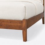 Footboard close-up of a modern upholstered bed, showing a square corner post, plain foot rail and tapered leg.