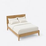 High angled view of a modern platform bed, looking down on the plain low rails, flat headboard and tapered legs.