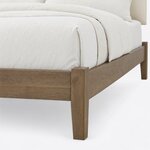 Footboard close-up of a modern upholstered bed, showing a flat-topped square corner post, plain rails and a tapered leg.