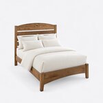 High angled view of a modern slat bed, looking down on the arched slatted headboard and a low footboard with a curved apron.