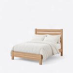 Diagonal angled view showing the left side of a minimalist slat bed, with a slatted headboard and a low solid footboard.
