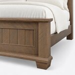 Footboard close-up of a transitional panel bed, showing the overhanging cap, a planked panel, plinth base and block foot.