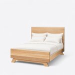 Diagonal angled view showing the left side of a contemporary panel bed, with a slab headboard and footboard on splayed feet.