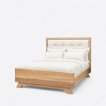 Diagonal angled view showing the left side of a contemporary upholstered bed, with a tufted headboard and flared feet.