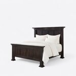 Diagonal angled view showing the left side of a Shaker panel bed, with a dentil-trimmed four-panel headboard and footboard.