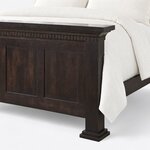Footboard close-up of a Shaker panel bed, showing dentil molding under the cap, recessed panels and a stepped plinth foot.