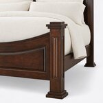 Footboard close-up of a traditional poster bed, showing a paneled square post with a stepped cap and a plinth foot.