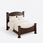 High angled view of a traditional poster bed, looking down on the curved footboard, side rail and capped corner posts.