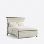 Diagonal angled view showing the right side of a traditional panel bed, with turned columns and a low two-panel footboard.