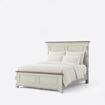 Diagonal angled view showing the left side of a traditional panel bed, with turned columns and a low two-panel footboard.