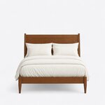 Front view of a modern panel bed, showing a flat-panel headboard between square posts and a low footboard on tapered legs.
