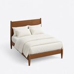 High angled view of a modern panel bed, looking down on the plain side rails, the low footboard and the tapered square legs.