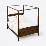 High angled view of a classic canopy bed, looking down on the open canopy frame, tapered posts and solid footboard.