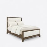 Diagonal angled view showing the right side of a modern upholstered bed, with a framed upholstered headboard and footboard.