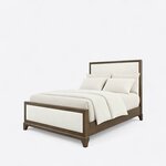 Diagonal angled view showing the left side of a modern upholstered bed, with a framed upholstered headboard and footboard.