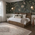 Diagonal angled room view showing the left side of a bookcase storage bed with drawers, in a floral-papered bedroom.