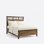 Diagonal angled view showing the right side of a contemporary panel bed, with a lattice-top headboard and a low footboard.
