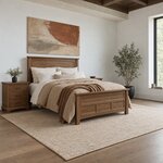 Diagonal angled room view showing the right side of a transitional panel bed with a paneled footboard, in a white bedroom.