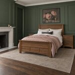 Diagonal angled room view showing the left side of a transitional panel bed with square posts, in a green-paneled bedroom.