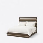 Diagonal angled view showing the left side of a modern panel bed, with a metal-banded headboard and a low footboard.