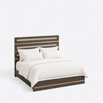 High angled view of a modern panel bed, looking down on the tall banded headboard and the low metal-banded footboard.