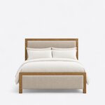 Front view of a contemporary upholstered bed, showing a tall framed headboard, a low upholstered footboard and square legs.