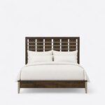 Front view of a modern slat bed, showing a tall headboard of flat slats crossed by metal bars and a low capped footboard.