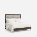 Diagonal angled view showing the right side of a modern upholstered bed, with a grid headboard and horizontal metal bars.