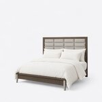 Diagonal angled view showing the left side of a modern upholstered bed, with a grid headboard and horizontal metal bars.
