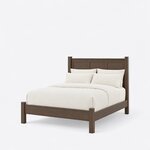 Diagonal angled view showing the left side of a transitional panel bed, with a three-panel headboard and capped posts.