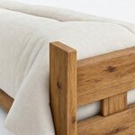 Headboard close-up of a rustic bed, showing a flat-topped rectangular post and a broad horizontal board with eased edges.