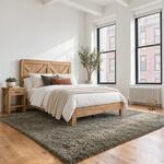 Diagonal angled room view showing the right side of the Fulton bed with a braced headboard, in a tall-windowed bedroom.