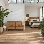 Front room view of a modern dresser with six flat-front drawers, in a plant-filled bedroom with a skylight.