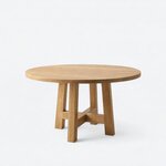 Diagonal angled view showing the left side of a modern pedestal dining table, with a round top and an open-frame base.