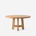 Front view of a modern pedestal dining table, with a broad round top over a symmetrical base with a low stretcher.
