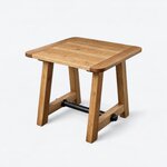 Diagonal angled view showing the left side of a rustic coffee table, with a plank top and a round metal stretcher.