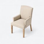 High angled view of an upholstered armchair, showing a broad seat narrowing toward the back between low arms.