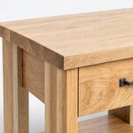 Top corner close-up of a rustic nightstand, with a projecting slab top, an eased edge and a broad corner post.