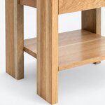 Leg close-up of a rustic nightstand, with a straight rectangular leg and a lower shelf raised above the floor.