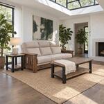 Diagonal angled room view showing the right side of an industrial coffee table with a low shelf, in a sunlit living room.