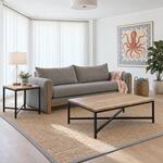 Diagonal angled room view showing the right side of an industrial end table with a metal frame, in a coastal living room.