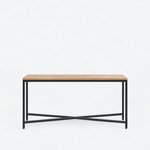 Front view of an industrial console table, with a long slab top on four square metal legs and a low X-brace.