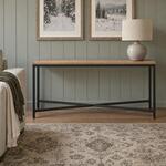 Front room view of an industrial console table with an X-braced metal base, in a vertically paneled living room.